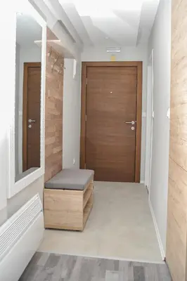 a hallway with a door and a bench in front of it at Milmari Resort, Apartman Premier 27 in Kopaonik