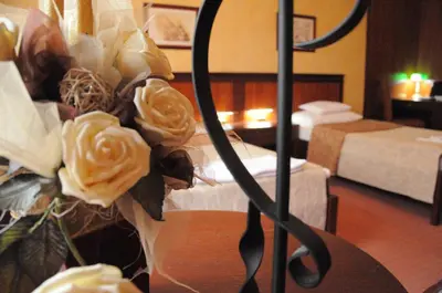 a bouquet of yellow roses in a hotel room at The Regent Club Hotel in Niš