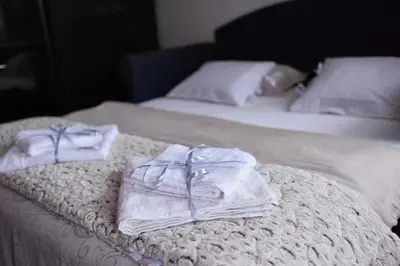 two towels sitting on top of a bed at Blue House Apartment in Niš