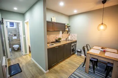 a kitchen with a table and a dining room at View - Apartment at Kopaonik in Kopaonik