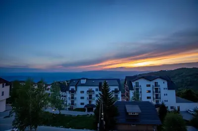 a view of a city at sunset at View - Apartment at Kopaonik in Kopaonik