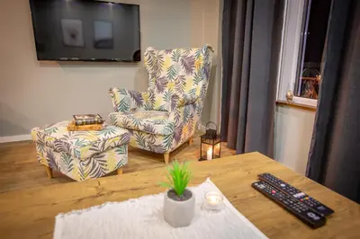 a living room with a chair and a table at View - Apartment at Kopaonik in Kopaonik