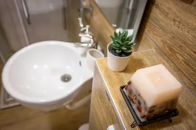 a bathroom with a sink and a cake on a counter at View - Apartment at Kopaonik in Kopaonik