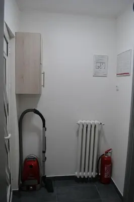 a room with a red vacuum and a radiator at Smestaj Pandora Sobe sa kupatilom in Jagodina