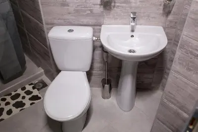 a bathroom with a white toilet and a sink at La Casa in Niš