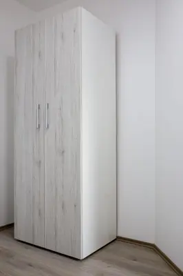 a white wardrobe in a room at La Casa in Niš