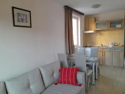 a living room with a couch and a table with chairs at Vila Paradi in Vrnjačka Banja