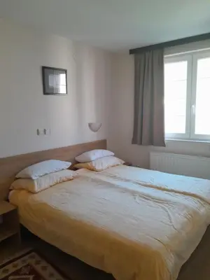 a bedroom with a large bed with two pillows at Vila Paradi in Vrnjačka Banja