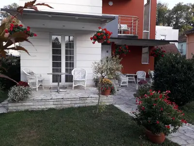 a patio with chairs and a table on a house at Vila Paradi in Vrnjačka Banja