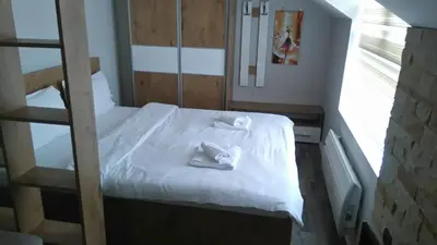 a small room with a bed with towels on it at Milmari, Resort, Premier Apartman A52 & Parking garage FREE in Kopaonik