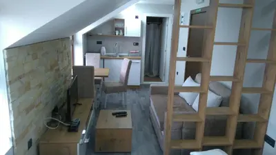 a small room with a staircase and a living room at Milmari, Resort, Premier Apartman A52 & Parking garage FREE in Kopaonik