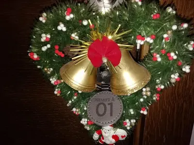 a christmas wreath with a clock and a bell at A1 Premier Milmari resort in Kopaonik
