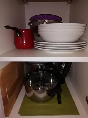 a shelf with plates and bowls and a mixer at A1 Premier Milmari resort in Kopaonik
