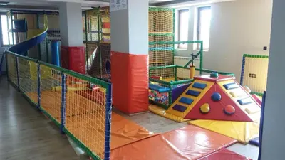a childrens play room with a tennis court at A1 Premier Milmari resort in Kopaonik