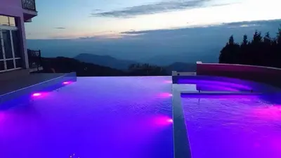 a swimming pool with purple lights on a house at A1 Premier Milmari resort in Kopaonik