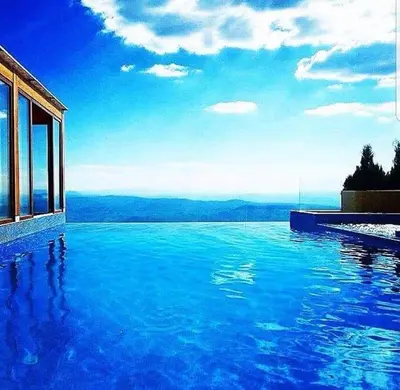 a swimming pool with a view of the water at A1 Premier Milmari resort in Kopaonik