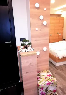 a bedroom with a wall with a smile sign and a bed at A1 Premier Milmari resort in Kopaonik