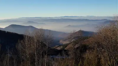 a view of a mountain with clouds in the distance at Apartman D52 Dvori in Kopaonik
