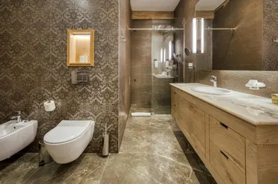 a bathroom with a toilet and a sink and a tub at Gorski Hotel & Spa in Kopaonik