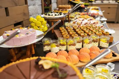 a buffet with many different types of food and desserts at Gorski Hotel & Spa in Kopaonik