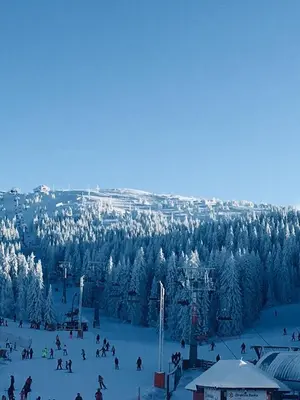 a group of people skiing on a snow covered slope at Iznad oblaka A9 in Kopaonik