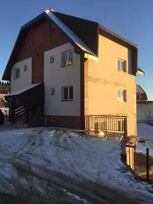 a building with snow on the ground in front of it at Iznad oblaka A9 in Kopaonik