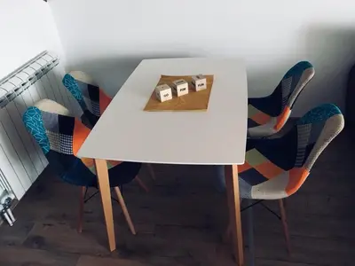 a white table with chairs and a box on it at Iznad oblaka A9 in Kopaonik