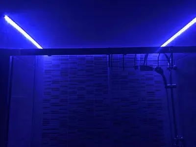 a bathroom with blue lights and a brick wall at Iznad oblaka A9 in Kopaonik