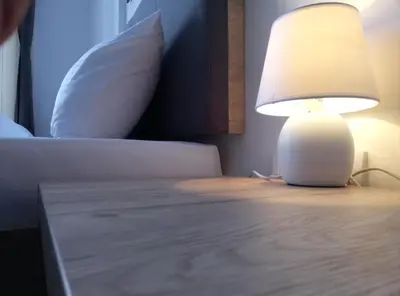 a lamp sitting on a table next to a bed at Apartman Šilja L22 Milmari Kopaonik in Kopaonik