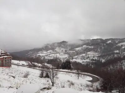 a view of a snow covered mountain with a road at Apartman Šilja L22 Milmari Kopaonik in Kopaonik