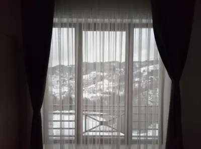 a window with a view of a city at Apartman Šilja L22 Milmari Kopaonik in Kopaonik