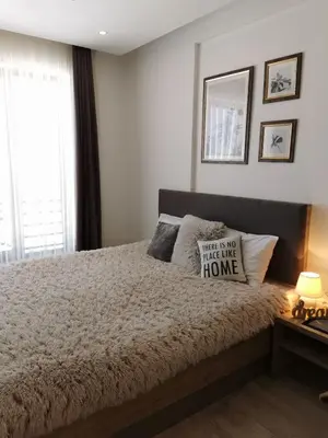 a bedroom with a large bed and a window at Apartman Šilja L22 Milmari Kopaonik in Kopaonik