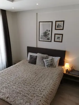 a bedroom with a bed with a comforter at Apartman Šilja L22 Milmari Kopaonik in Kopaonik