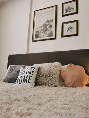 a bed with a white blanket and pillows on it at Apartman Šilja L22 Milmari Kopaonik in Kopaonik