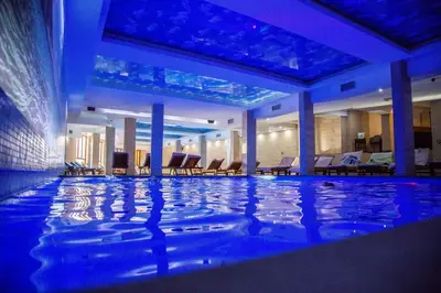 a swimming pool in a hotel with blue lighting at Milmari L29 in Kopaonik
