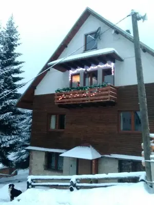 a building with a balcony with snow on it at Apartman Vila Natasa in Kopaonik
