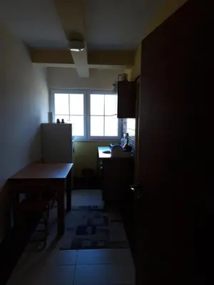 a dark room with a table and a window at Apartmani Nebrigic in Brzeće