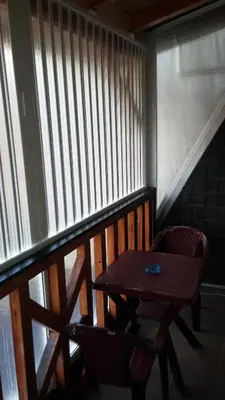 a balcony with a wooden table and two chairs at Apartmani Nebrigic in Brzeće
