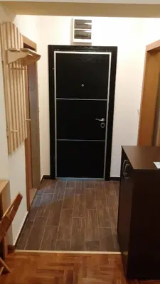 a black door in a room with a tile floor at Apartmani Nebrigic in Brzeće