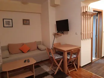 a living room with a couch and a table at Apartmani Nebrigic in Brzeće