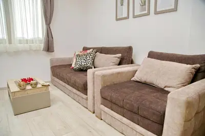 a living room with a couch and a chair at Kophill L36 Milmari in Kopaonik