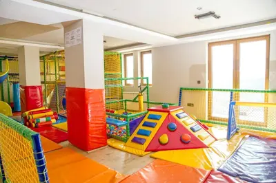 a childrens play room with colorful equipment in it at Kophill L36 Milmari in Kopaonik