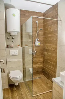a bathroom with a toilet and a glass shower at Kophill L36 Milmari in Kopaonik
