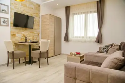 a living room with a couch and a table at Kophill L36 Milmari in Kopaonik