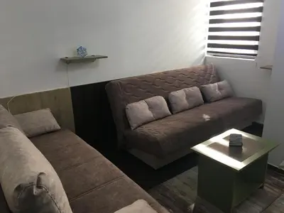 a living room with a couch and a table at Apartment Ramonda in Kopaonik