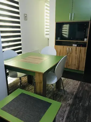 a conference room with a table and chairs and a tv at Apartment Ramonda in Kopaonik