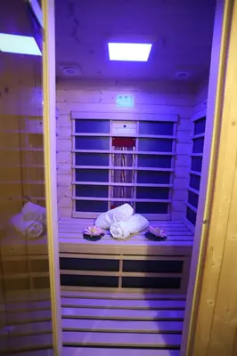 a purple room with two people sleeping in a cell at Garni Hotel Laguna Lux in Niš