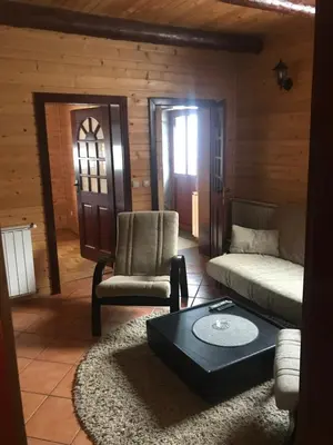 a living room with a couch and a coffee table at Villa Popara Kopaonik in Kopaonik