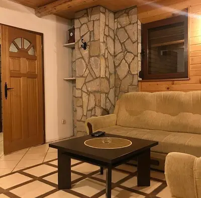 a living room with a couch and a coffee table at Villa Popara Kopaonik in Kopaonik