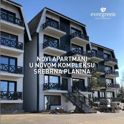 a building with a sign on the side of it at PROMO Evergreen apartments in Kopaonik